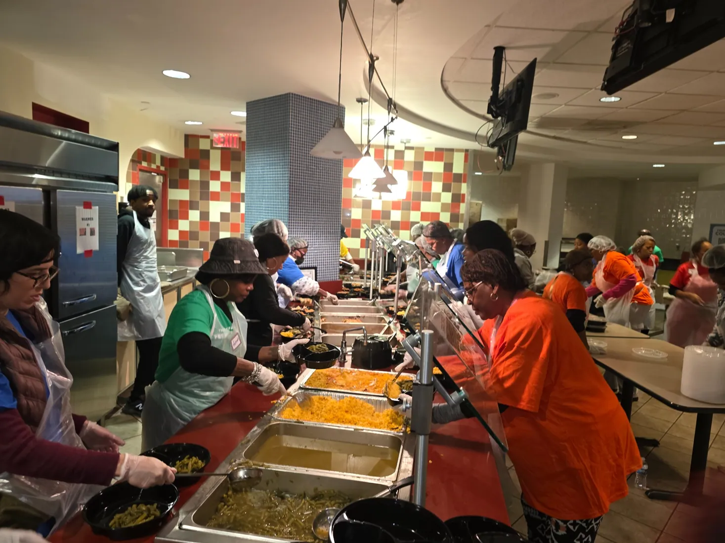 Volunteers serving meals at the gathering